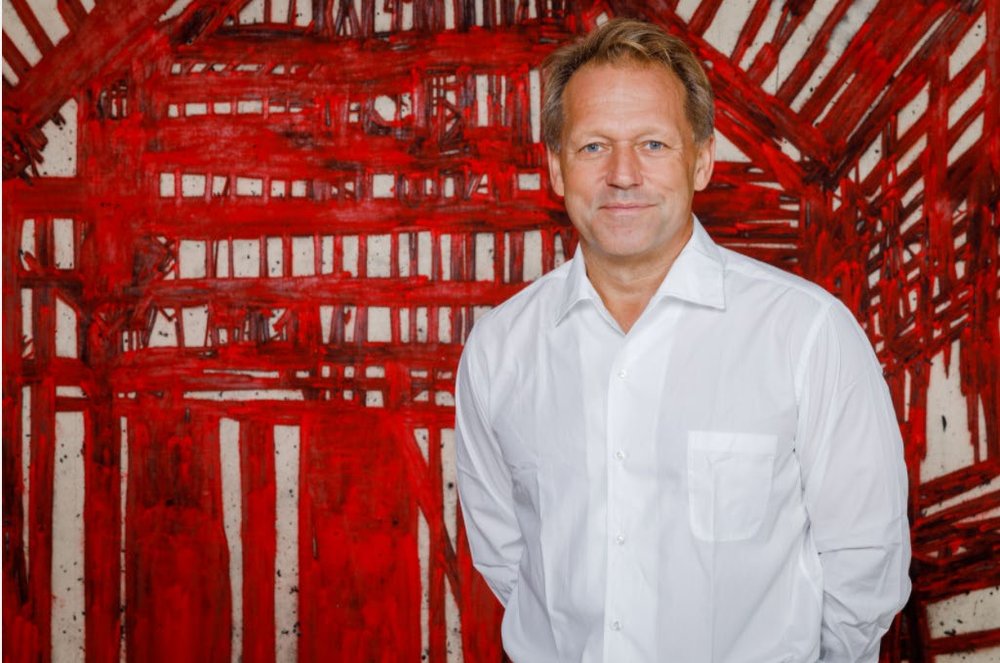 The British entrepreneur and philanthropist David Ross, before a red interior by Tony Bevan.