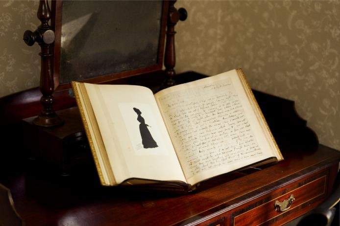 The recovered volume of Keats&rsquo;s love letters, shown open beside a silhouette portrait
