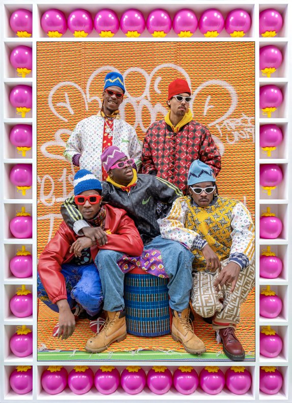 Hassan Hajjaj, group portrait from the My London Rockstars series, staged against graffiti with the artist&rsquo;s signature found-object frame