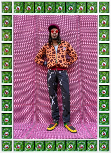 Hassan Hajjaj, full-length portrait in styled streetwear against a pink patterned backdrop, from the My Rockstars series